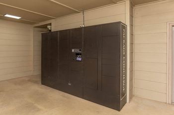 A large, dark brown, black colored, tall, and narrow freezer unit with the word "FREEZER" written on it.