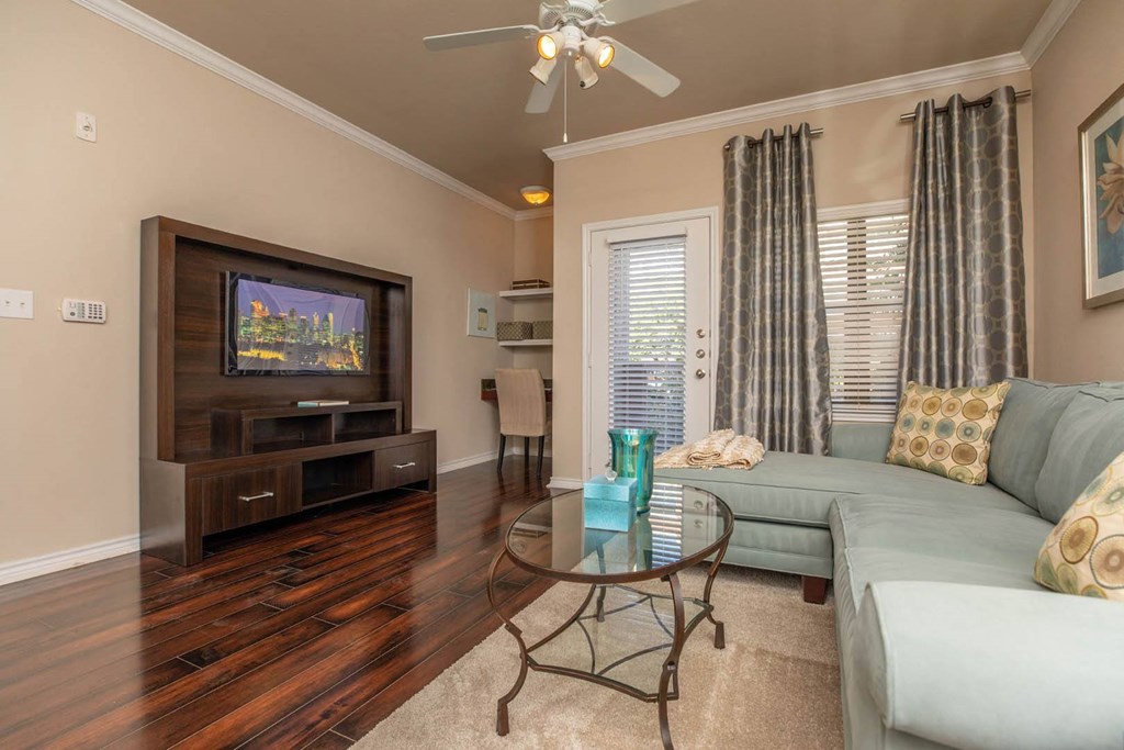 A living room with a television, couch, and coffee table.