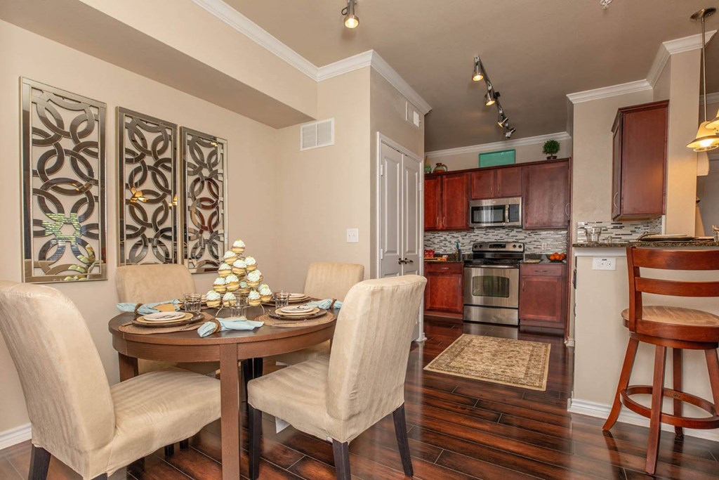 A dining room with a table set for four.