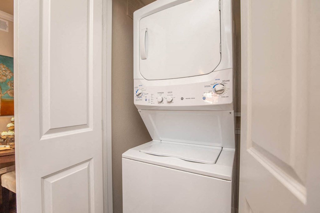 A white washing machine in a small laundry room.