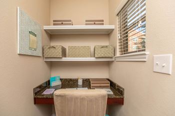 A bathroom with a toiletries organizer and a towel on a table.