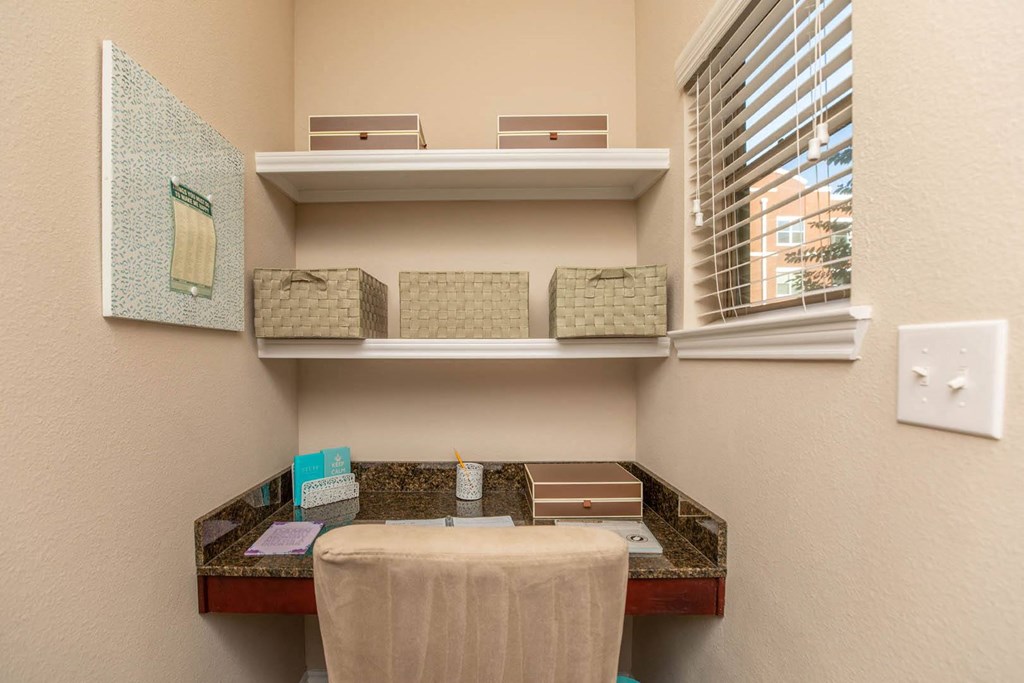 A bathroom with a toiletries organizer and a towel on a table.