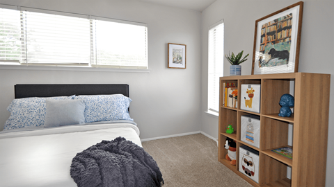 A bedroom with a white bed and a wooden bookshelf.