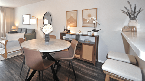 A dining room with a round table and chairs.