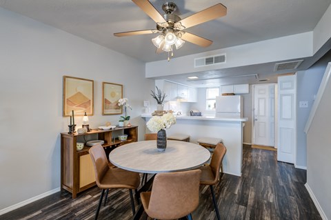 A dining room with a round table and chairs.