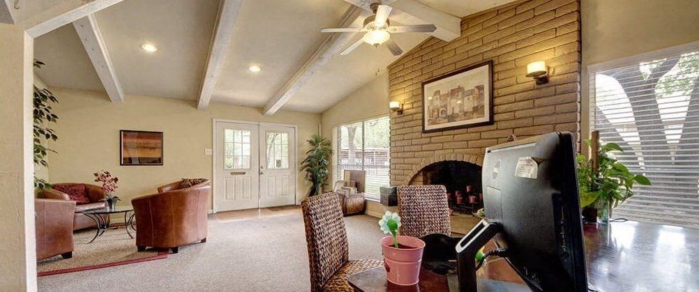 a living room with a fireplace and a television