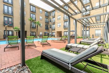 A patio area with sun loungers and a pool.
