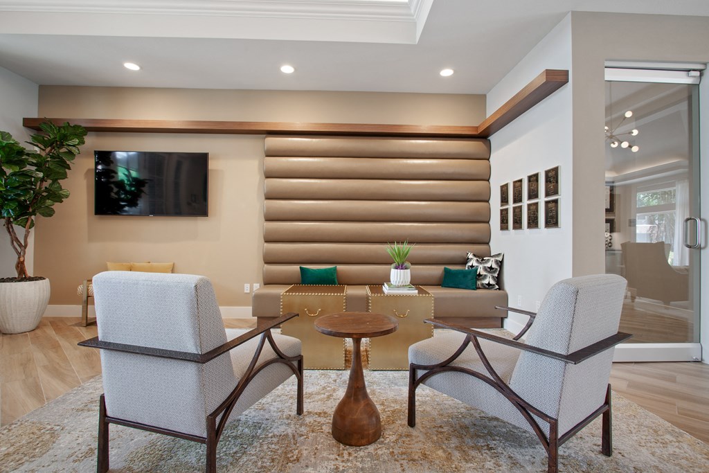 a living room with a table and chairs and a television