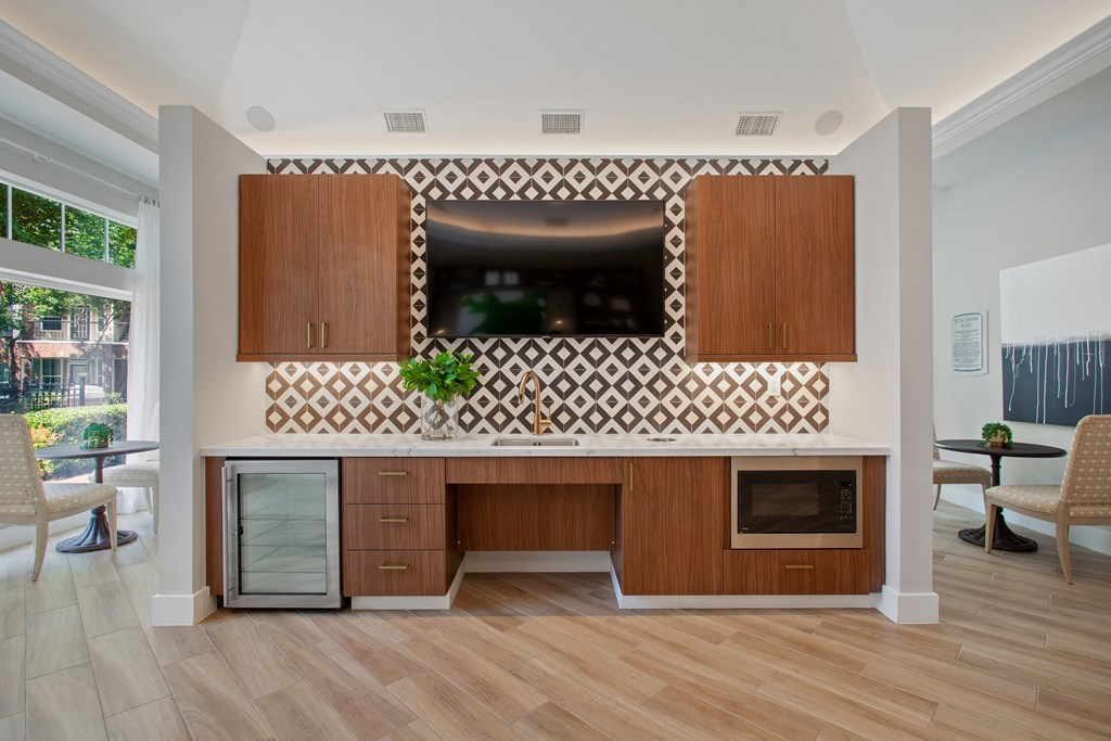 a kitchen with wooden cabinets and a counter top with a television