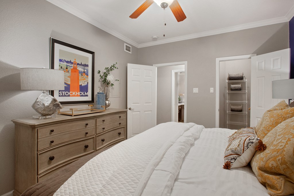 a bedroom with a large bed and a dresser