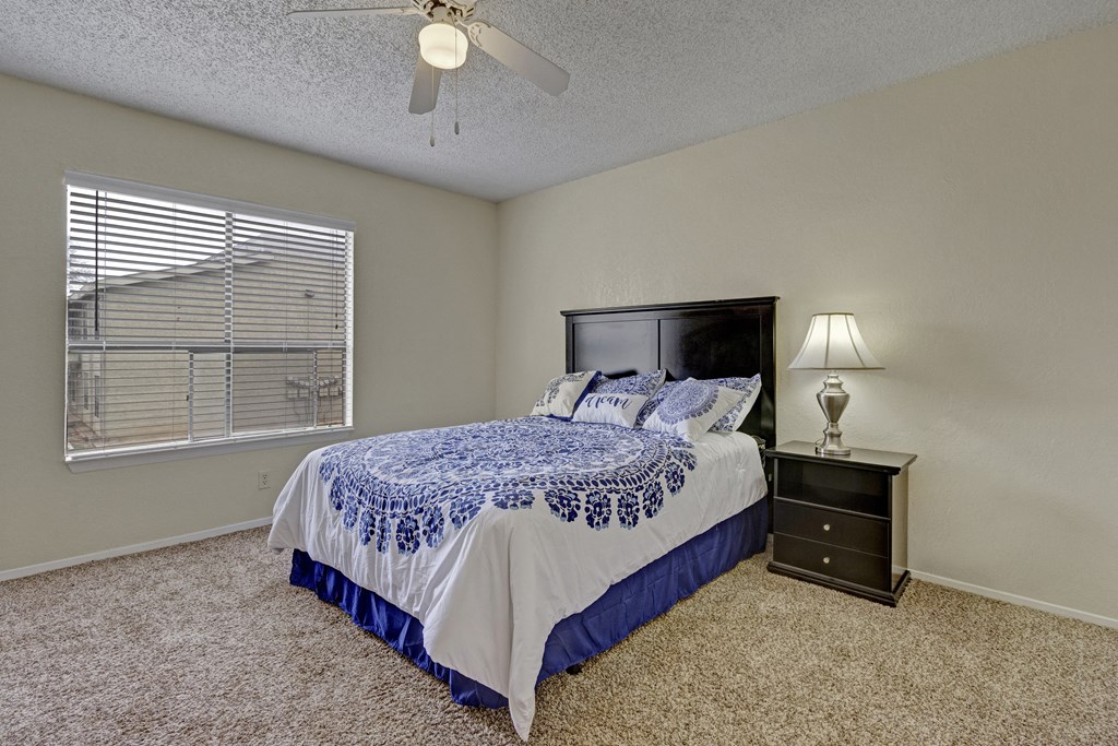 the master bedroom has a king sized bed and a window