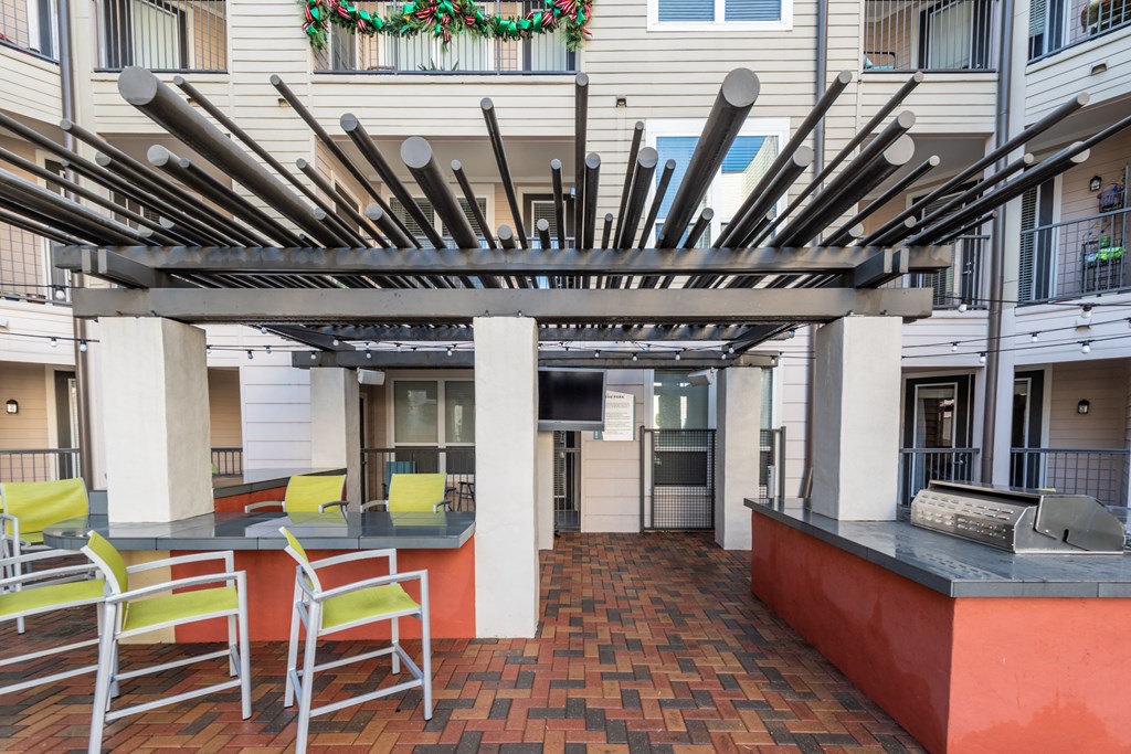a patio with a bar with chairs and knives on the ceiling