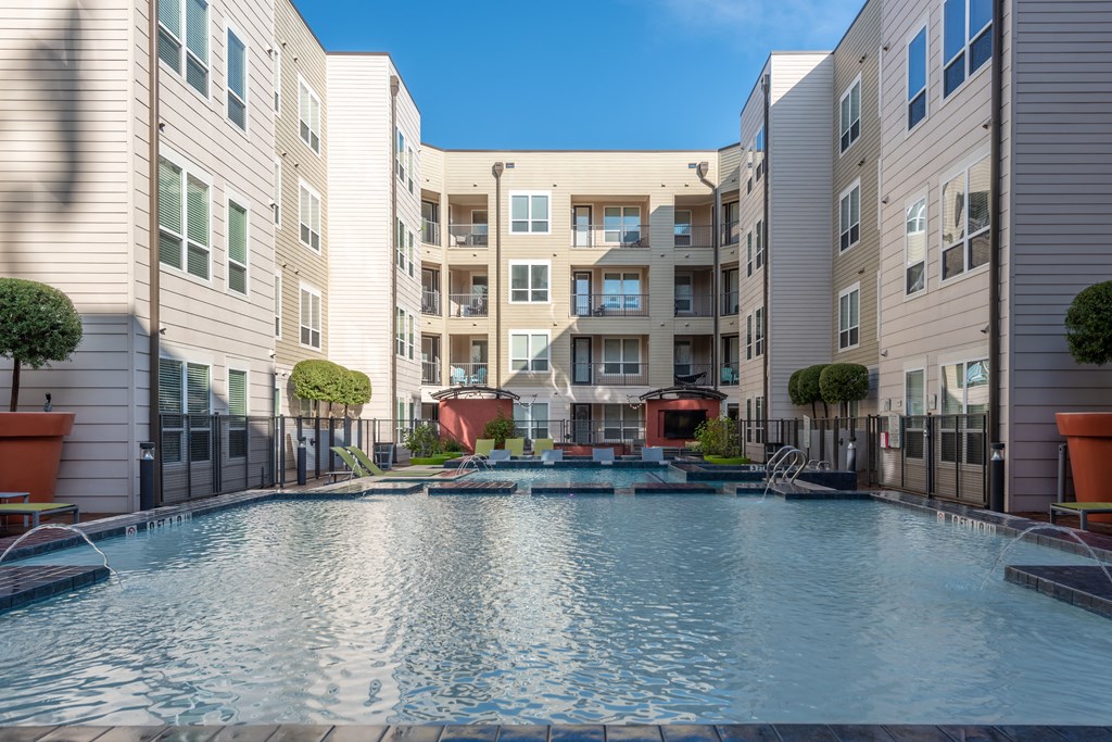 a swimming pool in front of an apartment building