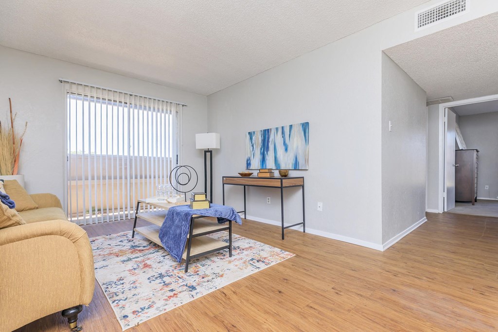 a living room with a couch and a table and a window