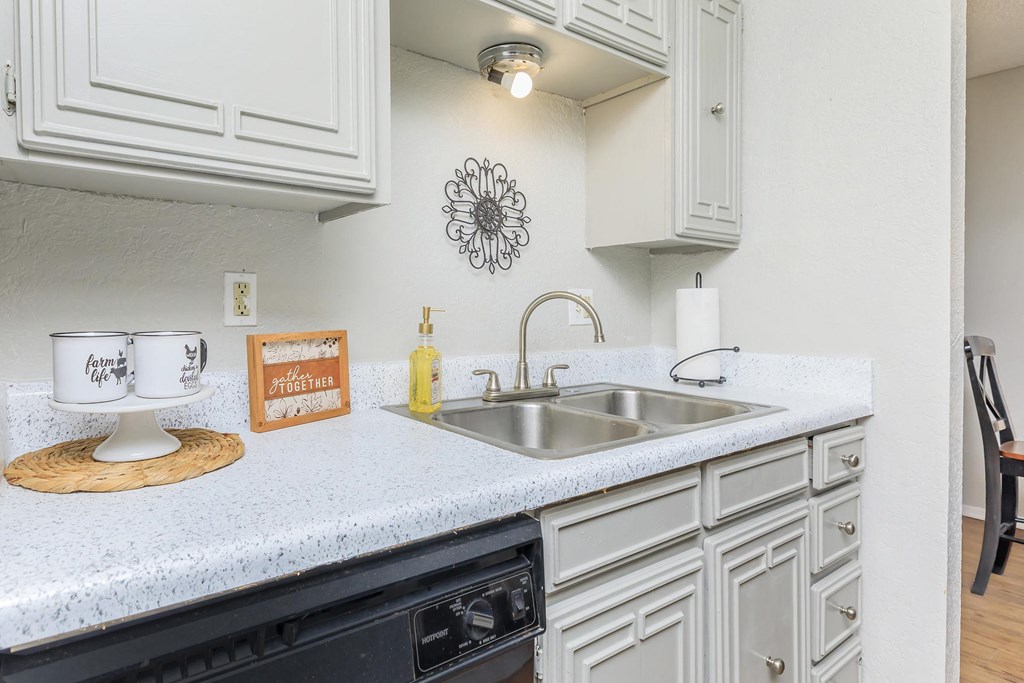 a kitchen with white cabinets and a sink