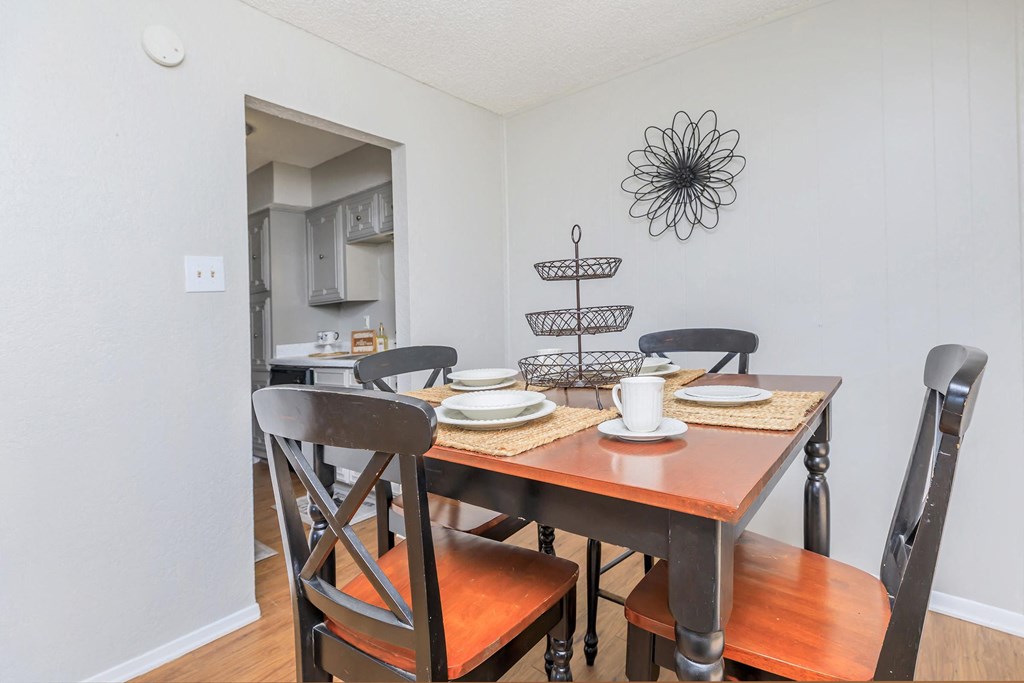 a dining room with a wooden table and chairs