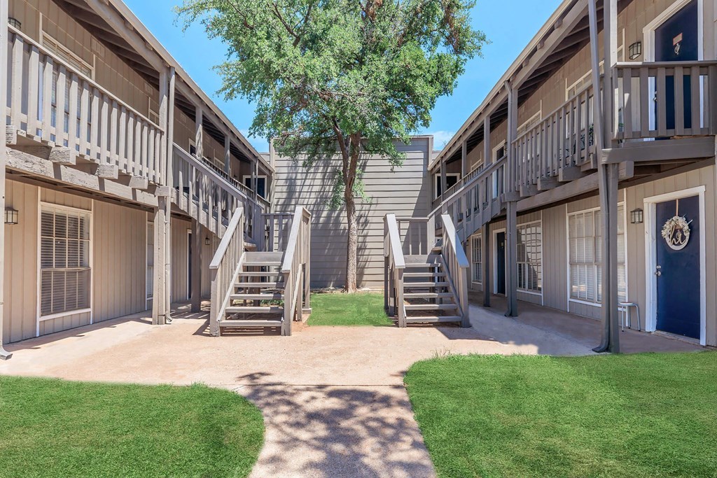 our apartments have a spacious courtyard with stairs and grass