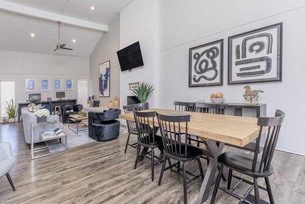 a living room with a wooden table and chairs