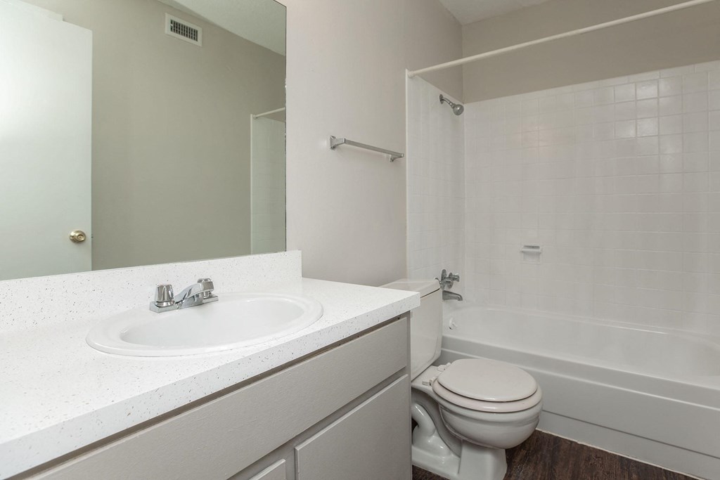 an empty bathroom with a sink toilet and shower