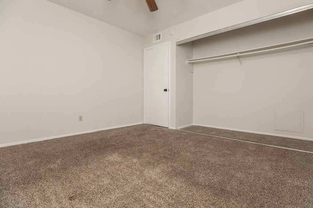 an empty room with carpet and a garage door