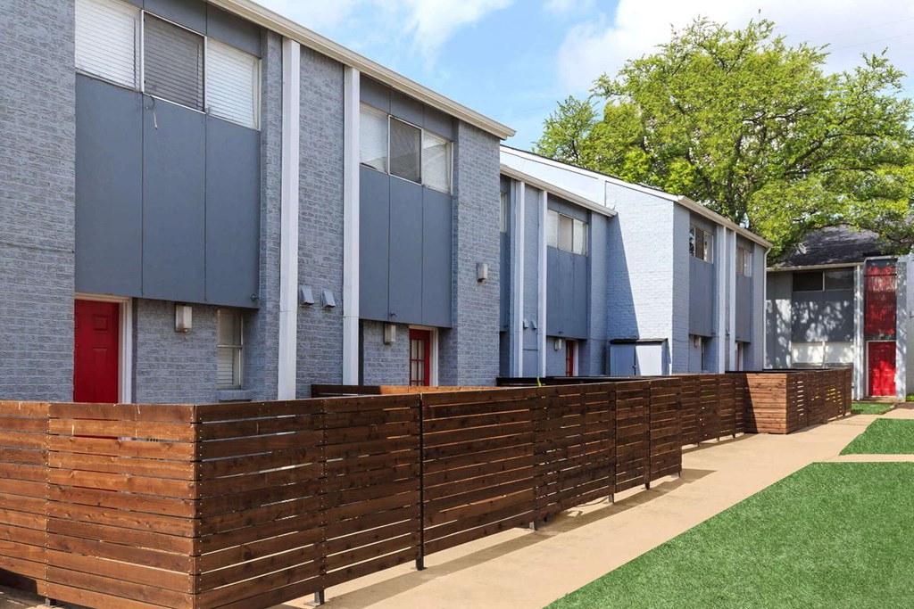 a row of houses with a wooden fence in front of them