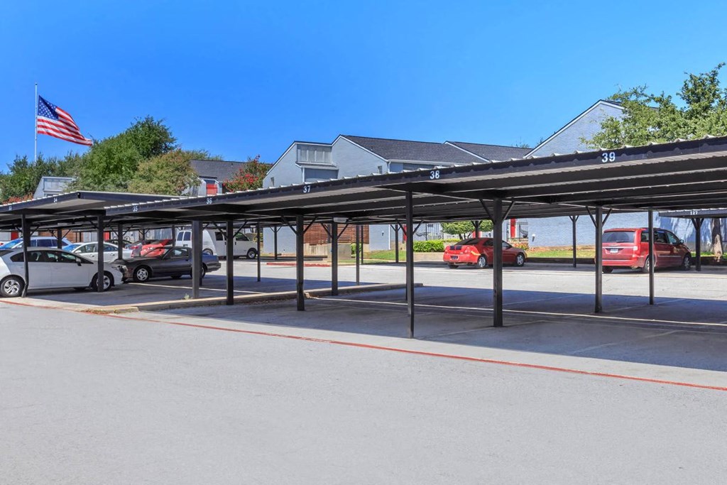 a covered parking lot with cars in a parking lot