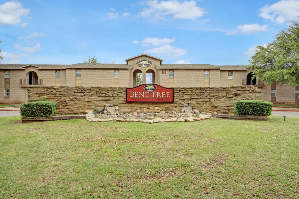 the building where the hotel is located has a brick wall with a sign on it