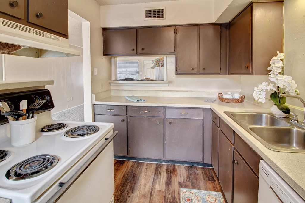a kitchen with white appliances and brown cabinets