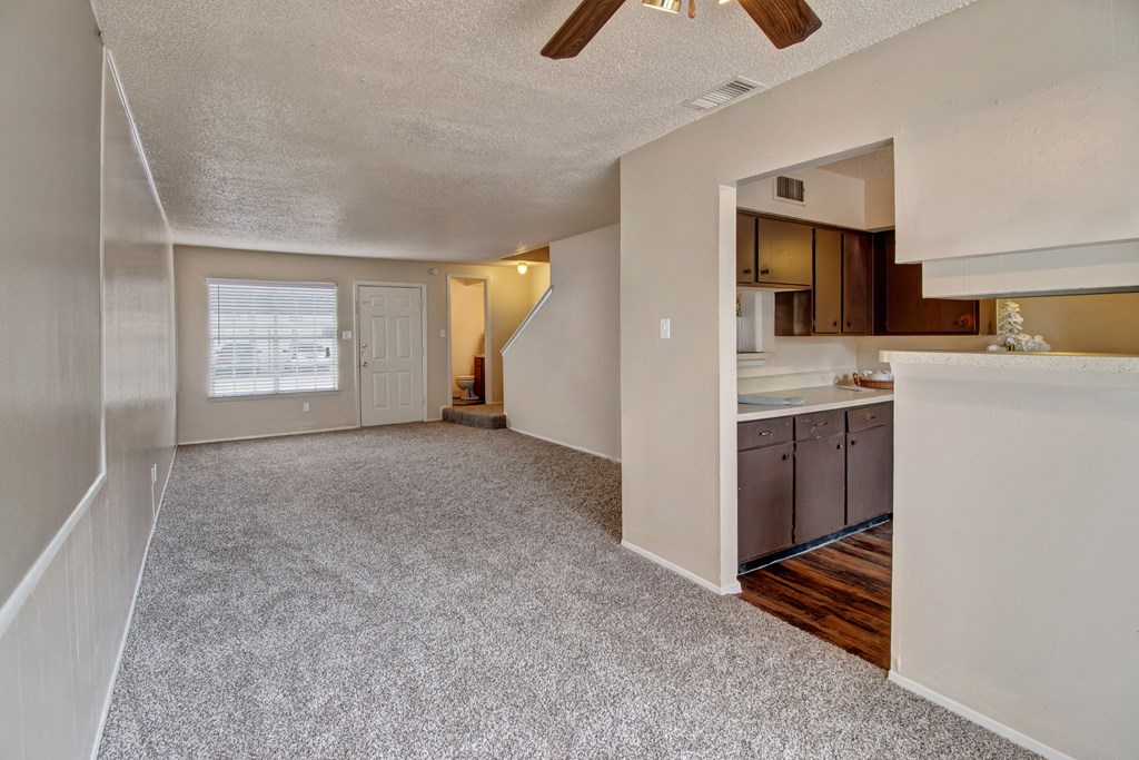 an open kitchen and living room with a ceiling fan