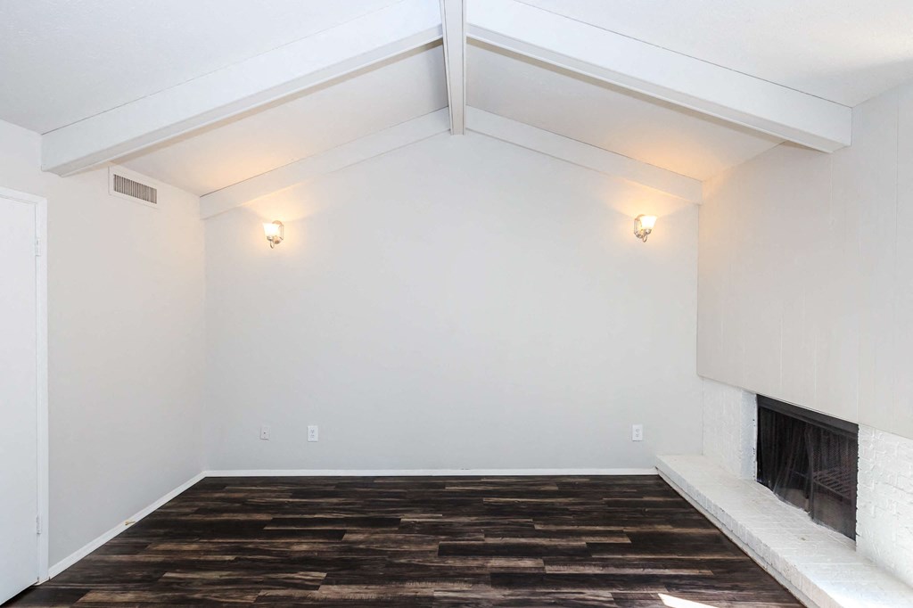 a living room with a fireplace and white walls