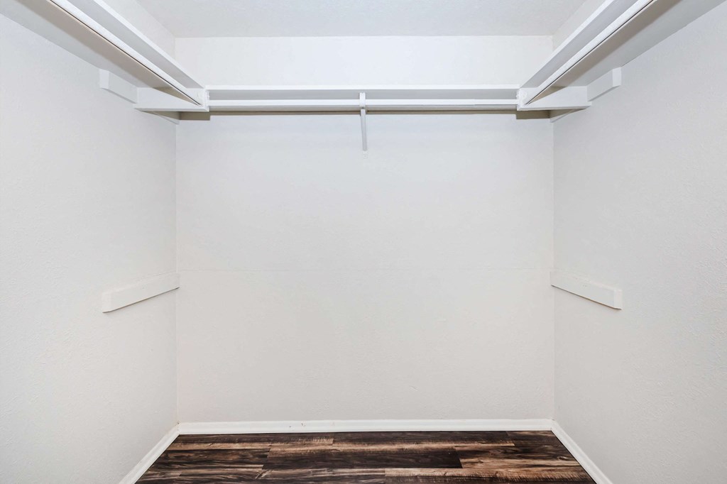 an empty room with white walls and a wood floor