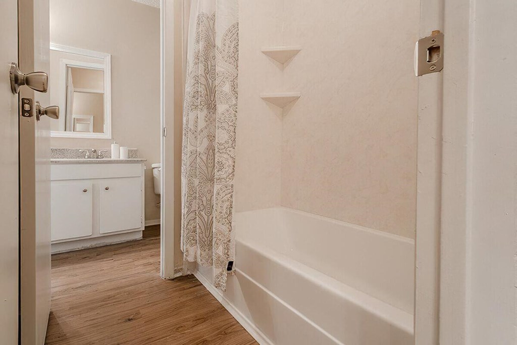 a bathroom with a tub and a shower curtain