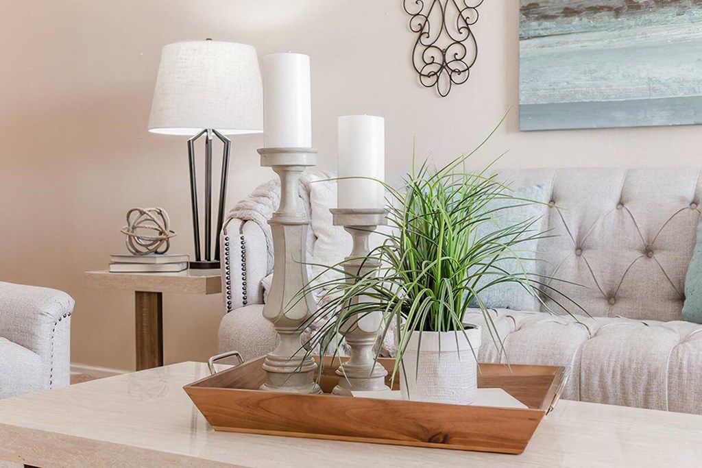 a living room with a table with candles and a couch