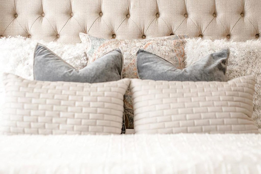 a bed with pillows on top of it