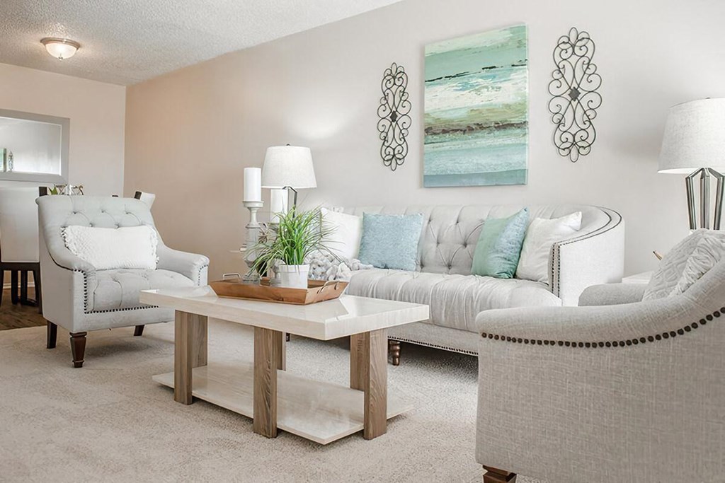a living room with couches and chairs and a table