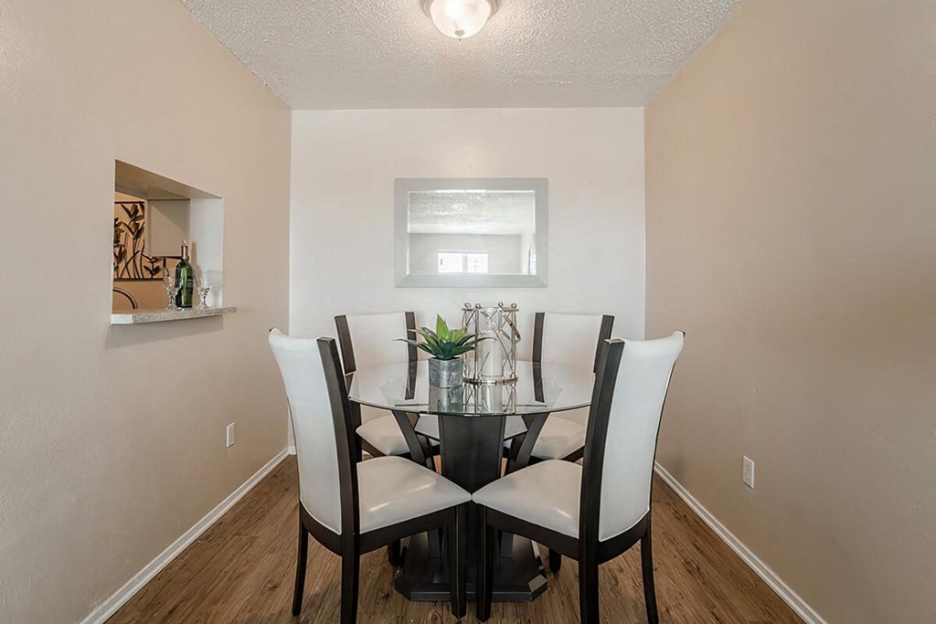 a dining room with a table and chairs