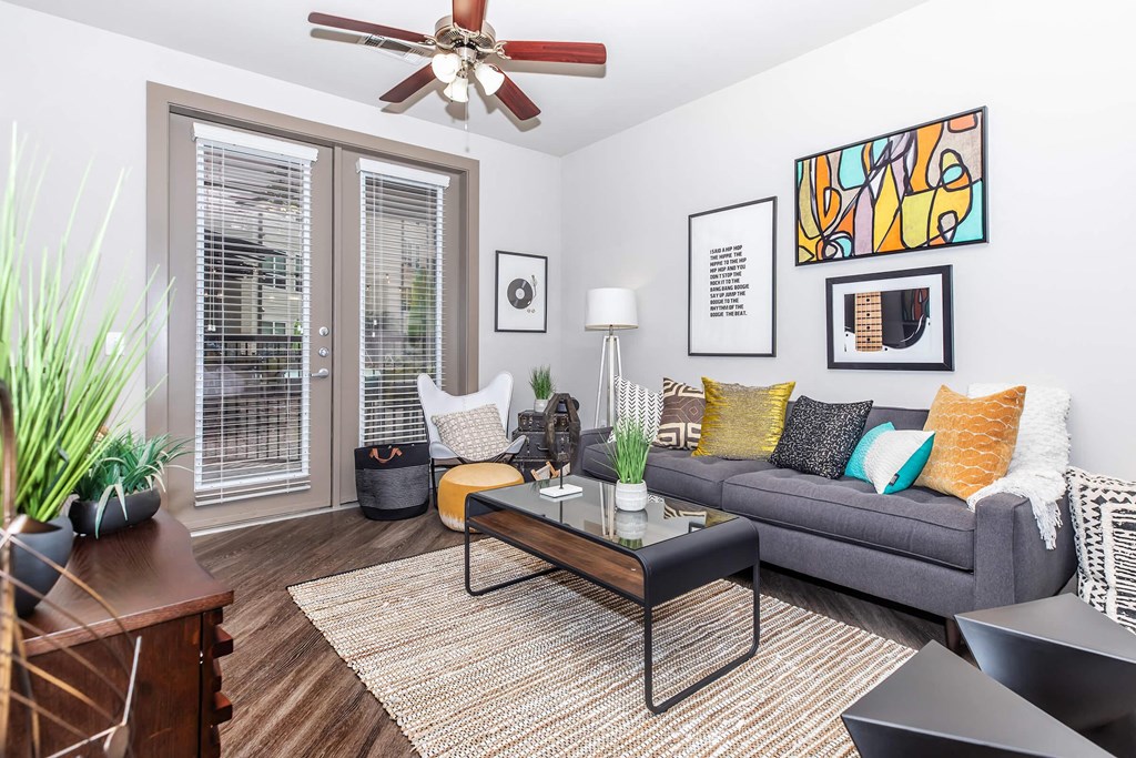 a living room with a couch and a ceiling fan