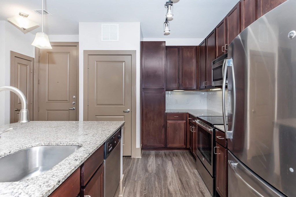 a kitchen with stainless steel appliances and granite counter tops