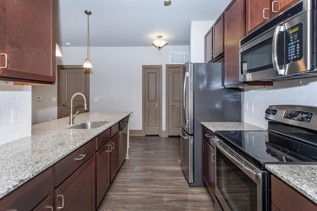 a kitchen with stainless steel appliances and granite counter tops