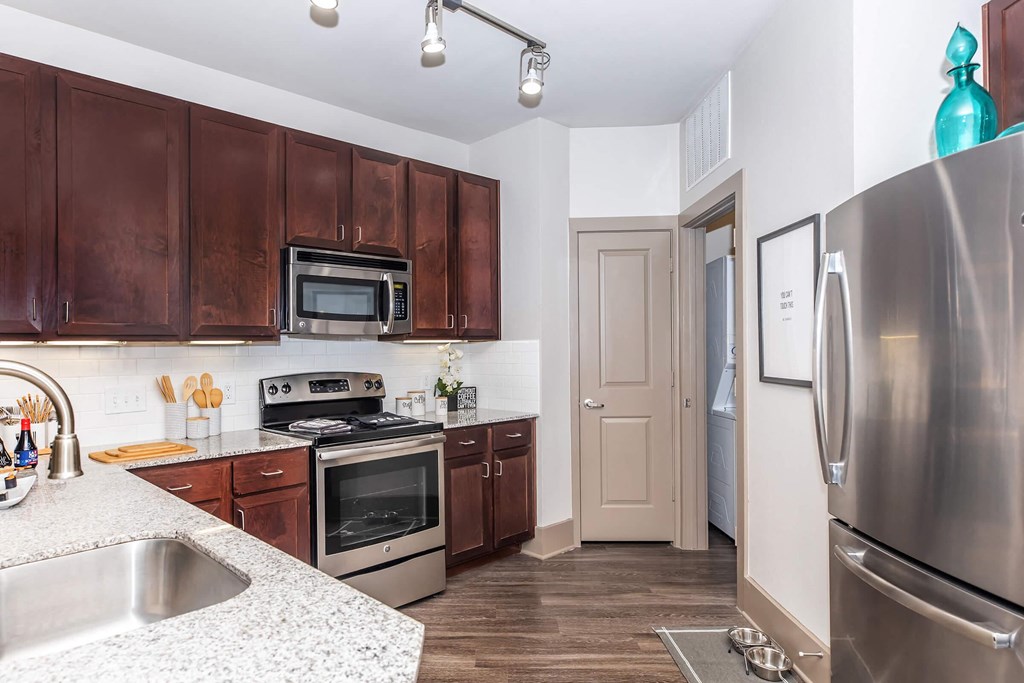 a kitchen with stainless steel appliances and wooden cabinets