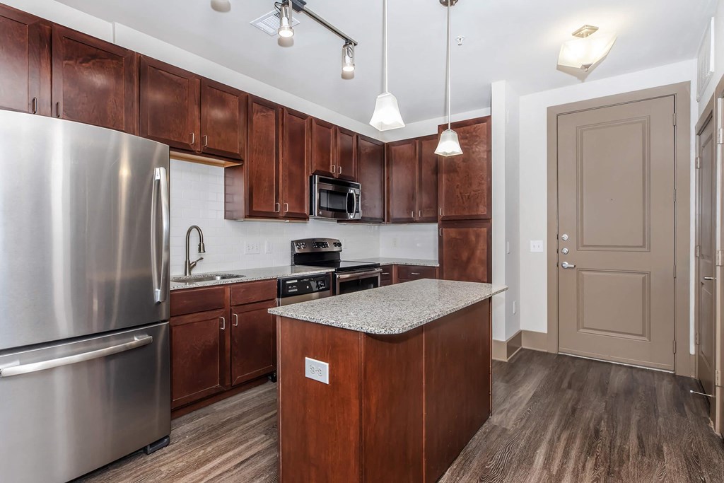 a kitchen with stainless steel appliances and wooden cabinets
