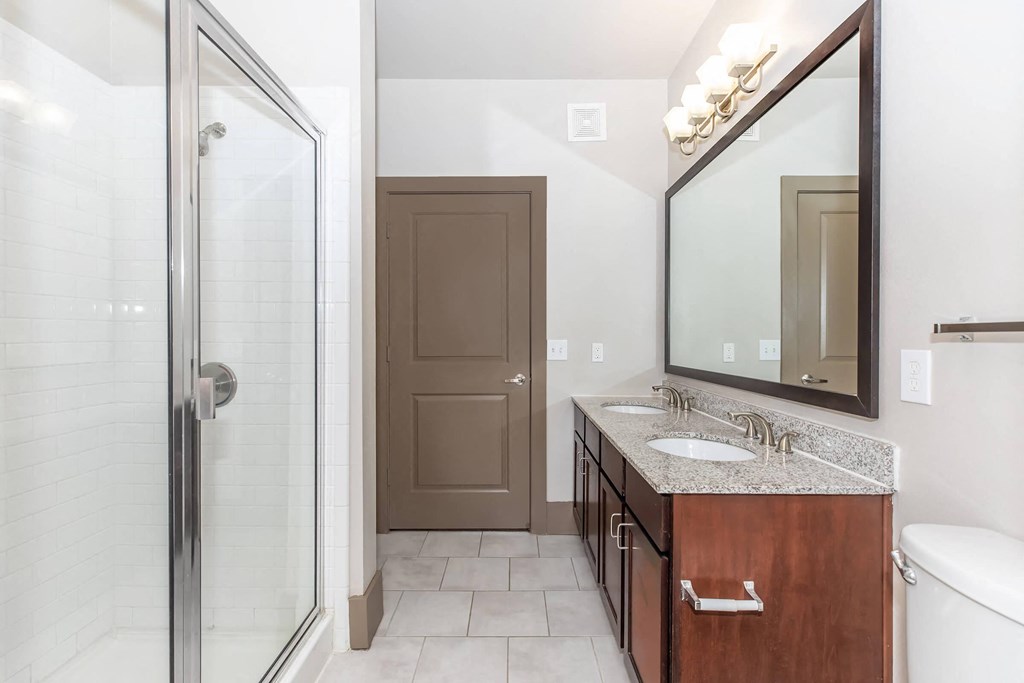 a bathroom with a shower and a sink and a mirror