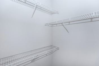 three white shelves on a wall in a foggy room