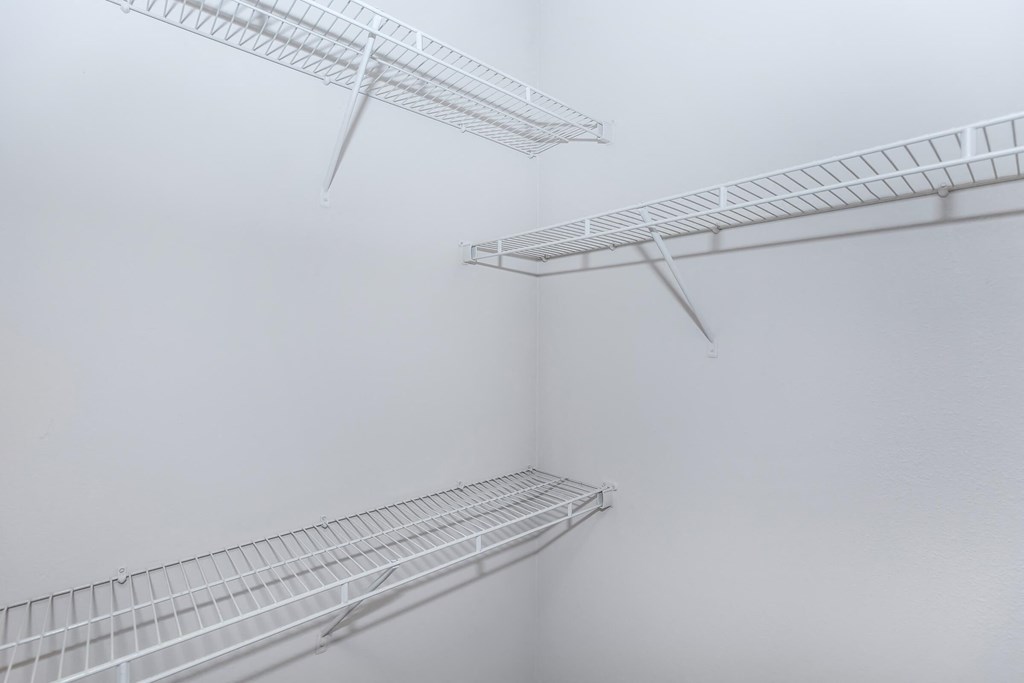 three white shelves on a wall in a foggy room