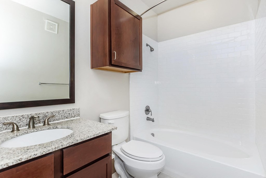a bathroom with a sink toilet and bath tub