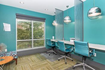 a conference room with chairs and a table and a window