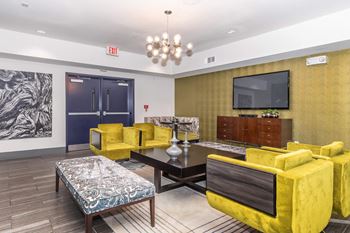 a living room with yellow furniture and a television