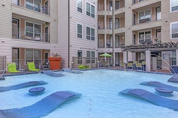 a large swimming pool in front of a building
