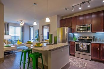 a kitchen with a counter top with green bar stools
