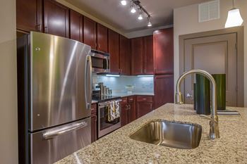 a kitchen with stainless steel appliances and granite counter tops